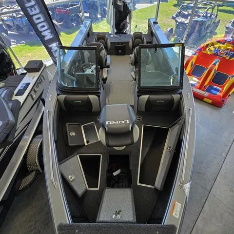 Slide: The Image of 2024 Lund 2075 Tyee boat interior with open storage compartments in showroom. - 4
