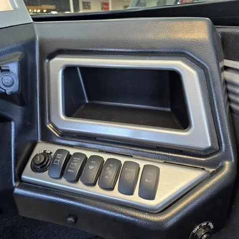 Slide: The Image of 2024 Lund 2075 Tyee dashboard with control panel and storage compartment. - 8