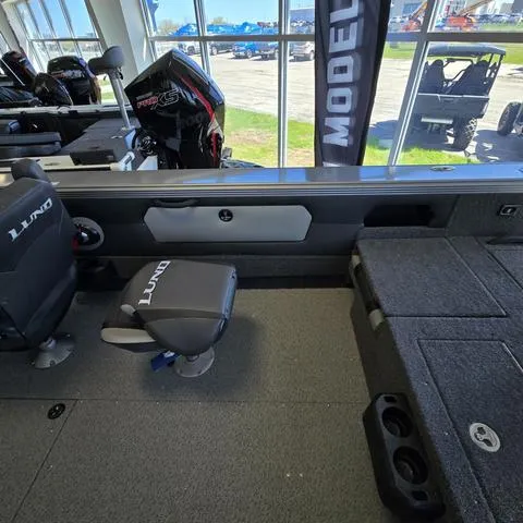 Slide: The Image of 2024 Lund 2075 Tyee boat interior with seating and storage compartments. - 9