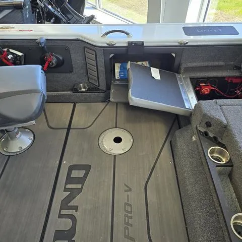 Slide: The Image of 2024 Lund 1875 Pro V Sport boat interior with storage compartments and seating. - 11