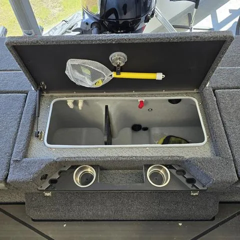 Slide: The Image of 2024 Lund 1875 Pro V Sport boat livewell with net and cup holders. - 12