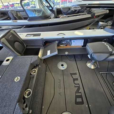 Slide: The Image of 2024 Lund 1875 Pro V Sport boat interior with seating and storage compartments. - 14