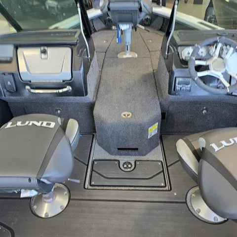 Slide: The Image of 2024 Lund 1875 Pro V Sport boat interior with dual seats and steering console. - 15