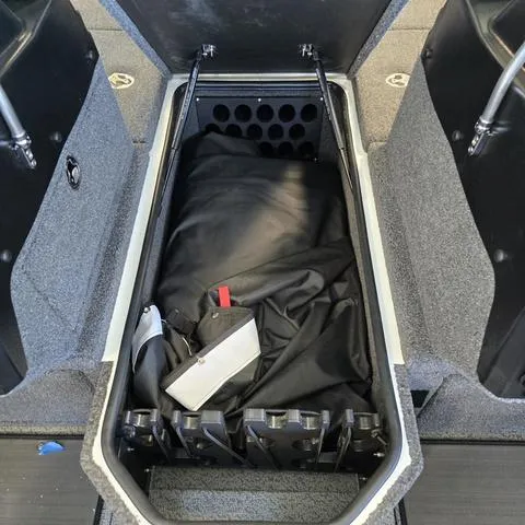 Slide: The Image of 2024 Lund 1875 Pro V Sport boat storage compartment with gear and accessories. - 4