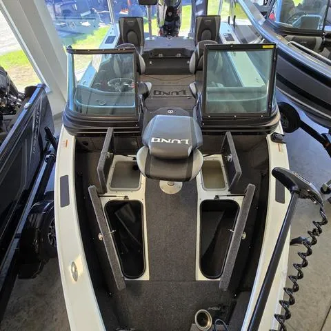 Slide: The Image of 2024 Lund 1875 Pro V Sport boat interior with open storage compartments. - 6