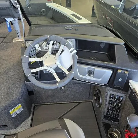Slide: The Image of 2024 Lund 1875 Pro V Sport boat interior with steering wheel and control panel. - 7