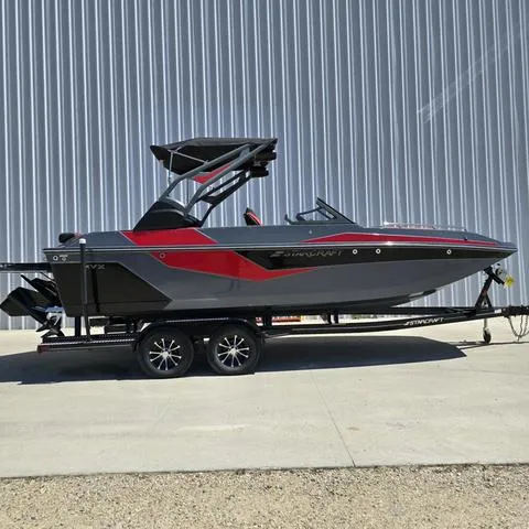 Slide: The Image of 2024 Starcraft MVX IO SURF boat on trailer, sleek design with red and gray accents. - 1