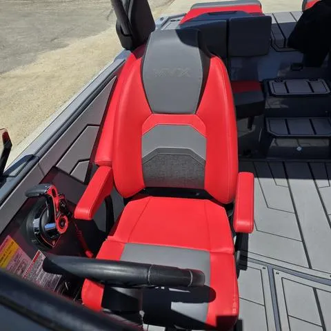 Slide: The Image of 2024 Starcraft MVX IO SURF boat seat, red and gray design, modern interior. - 10