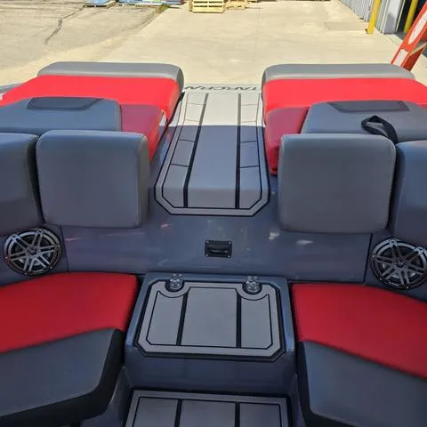 Slide: The Image of 2024 Starcraft MVX IO SURF boat interior with red and gray seating. - 14