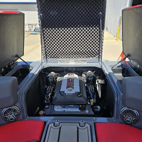 Slide: The Image of 2024 Starcraft MVX IO SURF boat engine compartment with open hatch, showcasing powerful engine. - 15
