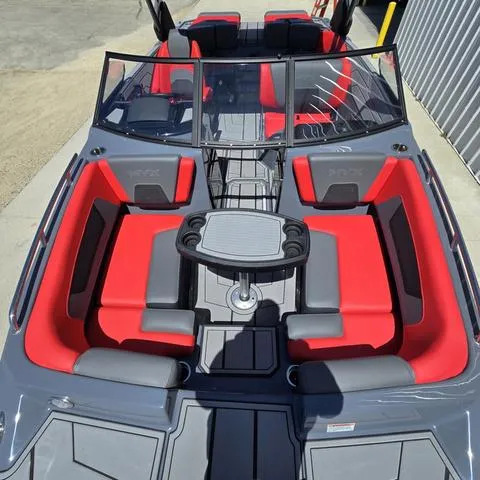 Slide: The Image of 2024 Starcraft MVX IO SURF boat with red and gray seating, featuring a central table. - 6