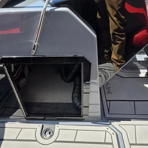 Slide: The Image of 2024 Starcraft MVX IO SURF boat interior storage compartment with sleek design and modern features. - 8
