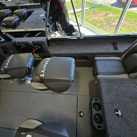 Slide: The Image of 2025 Lund 1875 Impact XS boat interior with seating and storage compartments. - 11