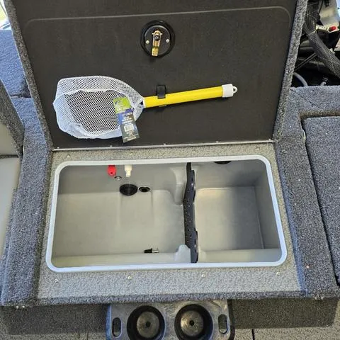 Slide: The Image of 2025 Lund 1875 Impact XS boat storage compartment with fishing net and secure latch. - 12