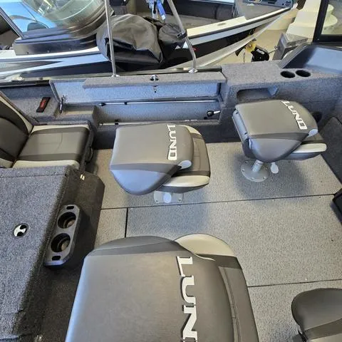 Slide: The Image of 2025 Lund 1875 Impact XS boat interior with seating and storage compartments. - 13
