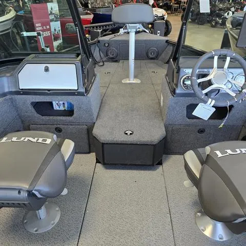 Slide: The Image of 2025 Lund 1875 Impact XS boat interior with seating and steering wheel. - 14
