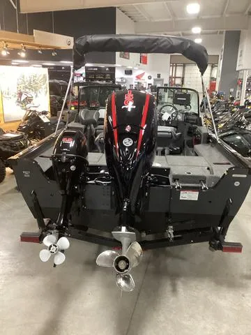 Slide: The Image of 2025 Lund 1875 Impact XS boat displayed in showroom, rear view with dual motors. - 3