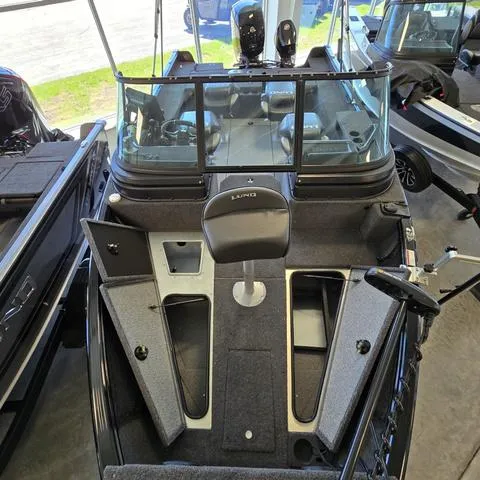 Slide: The Image of 2025 Lund 1875 Impact XS boat interior with open storage compartments and seating. - 6