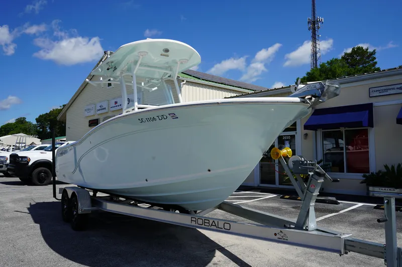 Slide: The Image of 2016 Sea Fox 246 Commander boat on a Robalo trailer in a parking lot. - 1