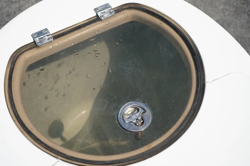 Slide: The Image of Livewell lid on a 2016 Sea Fox 246 Commander boat, featuring a secure latch. - 10