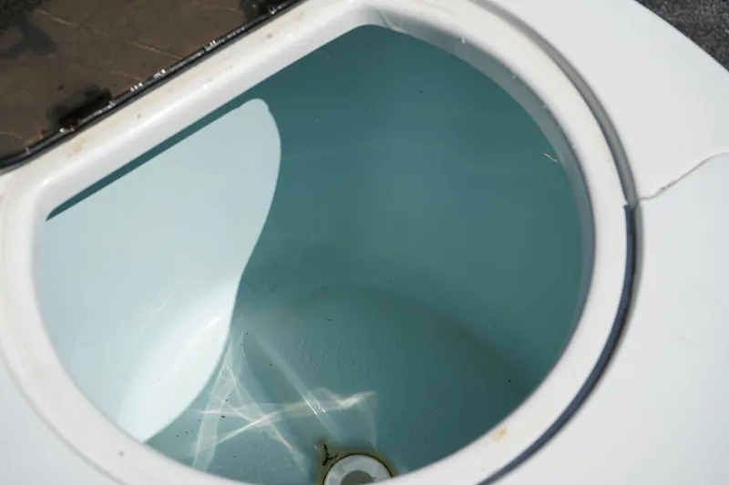 Slide: The Image of Livewell in 2016 Sea Fox 246 Commander boat, open lid, empty interior. - 11