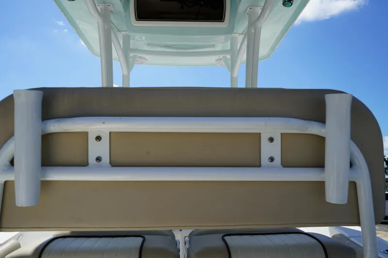 Slide: The Image of 2016 Sea Fox 246 Commander boat seating with rod holders and overhead console. - 16