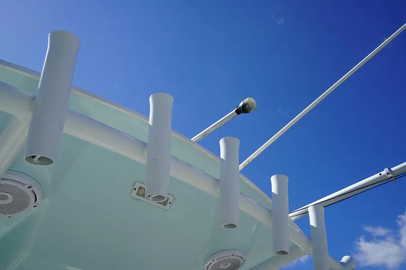 Slide: The Image of 2016 Sea Fox 246 Commander boat with rod holders against a clear blue sky. - 17
