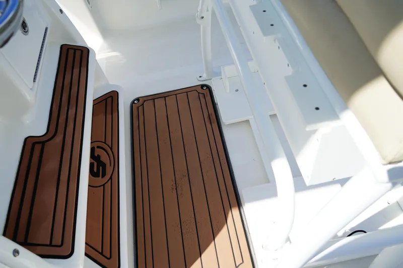 Slide: The Image of Interior view of 2016 Sea Fox 246 Commander boat with brown deck mats. - 22
