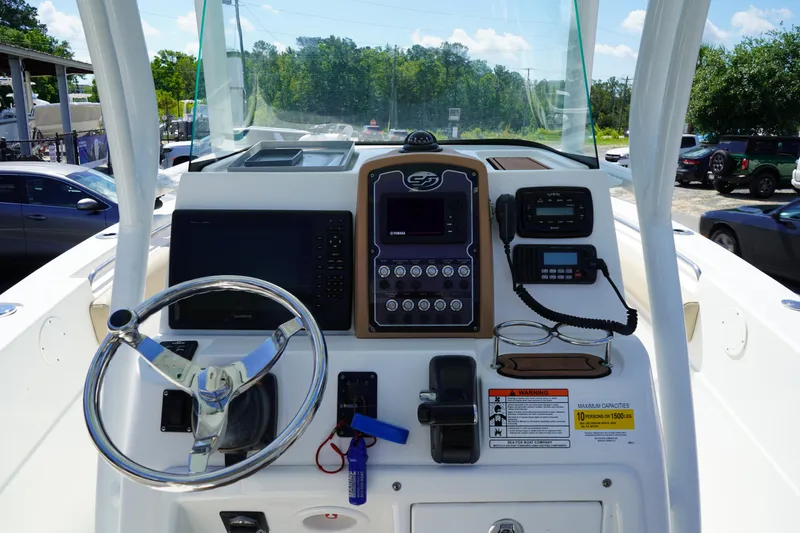Slide: The Image of 2016 Sea Fox 246 Commander boat dashboard with steering wheel and navigation controls. - 23