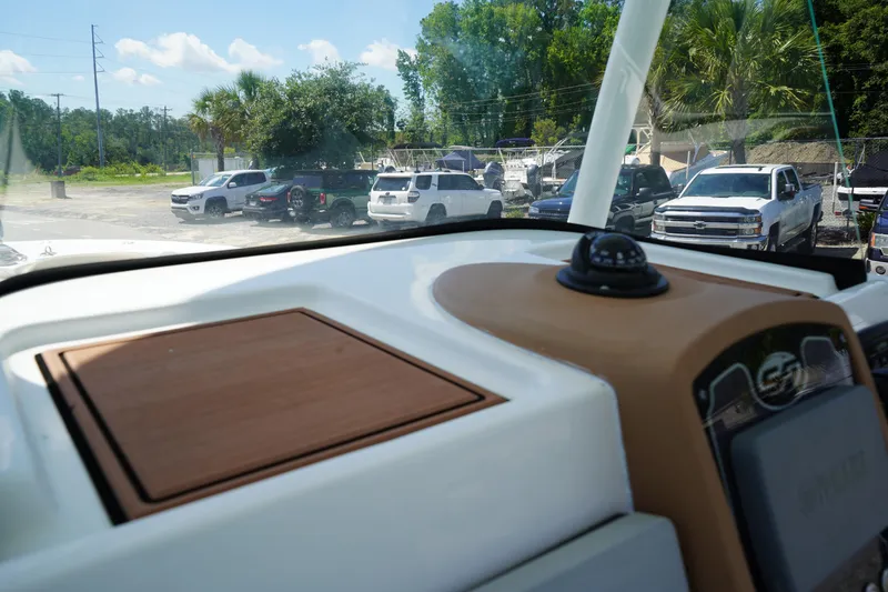 Slide: The Image of Dashboard view of a 2016 Sea Fox 246 Commander boat with parked cars in the background. - 26