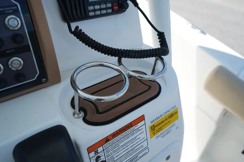 Slide: The Image of Control panel of 2016 Sea Fox 246 Commander with cup holders and warning label. - 31
