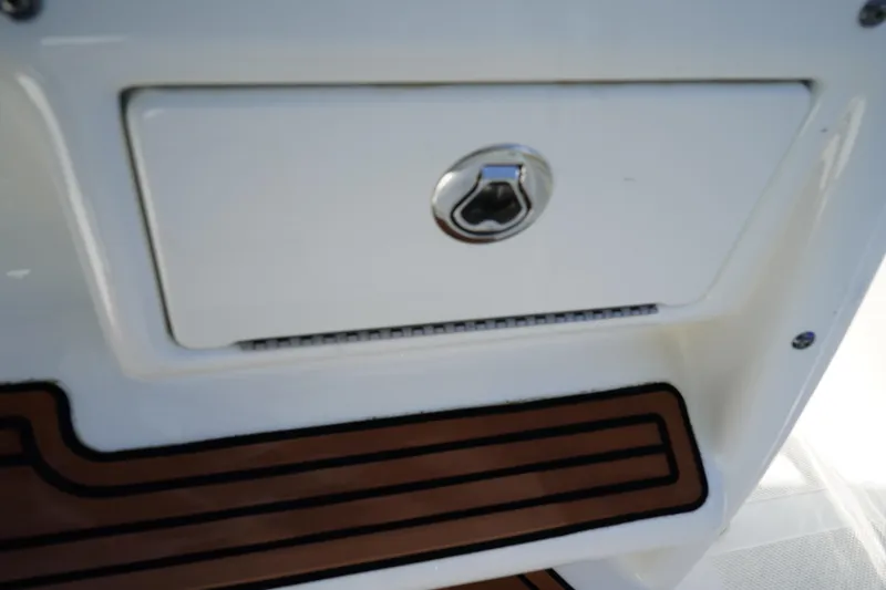 Slide: The Image of 2016 Sea Fox 246 Commander boat storage compartment with lock and teak flooring detail. - 32