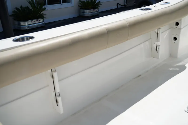 Slide: The Image of 2016 Sea Fox 246 Commander boat interior with cushioned side rail and rod holders. - 34