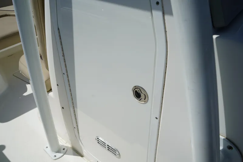 Slide: The Image of 2016 Sea Fox 246 Commander boat interior detail, featuring a white panel and latch. - 36