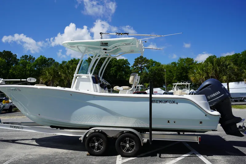 Slide: The Image of 2016 Sea Fox 246 Commander boat on trailer, parked outdoors under a clear blue sky. - 4
