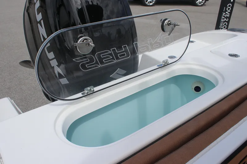 Slide: The Image of 2025 Sea Pro 222 boat with open livewell and Suzuki engine in background. - 10