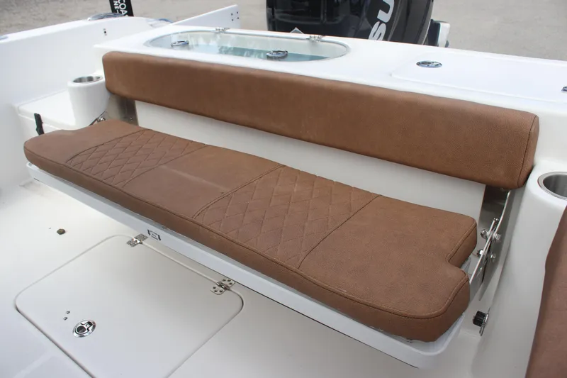Slide: The Image of 2025 Sea Pro 222 boat with brown cushioned seating and storage compartment. - 12
