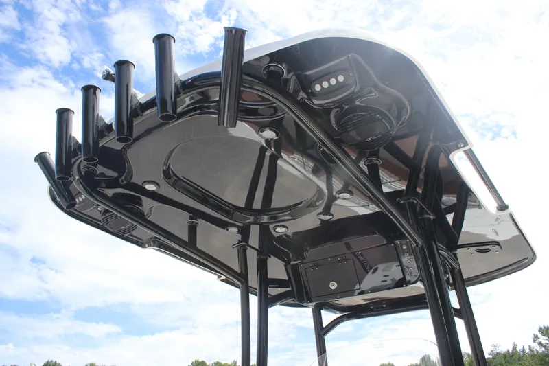 Slide: The Image of 2025 Sea Pro 222 boat T-top with rod holders against a blue sky. - 20