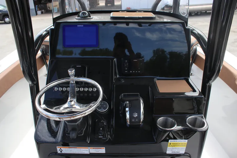 Slide: The Image of 2025 Sea Pro 222 boat dashboard with steering wheel, controls, and digital display. - 21