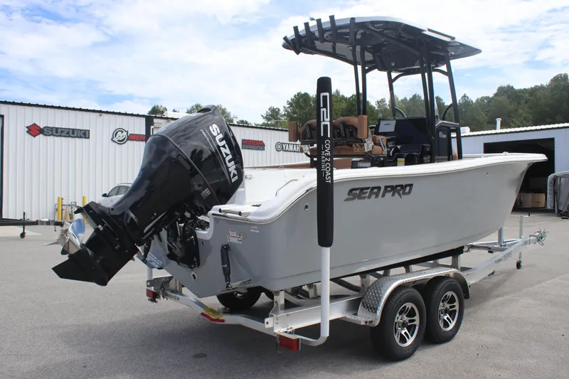 Slide: The Image of 2025 Sea Pro 222 boat on trailer with Suzuki outboard motor, parked outside dealership. - 3
