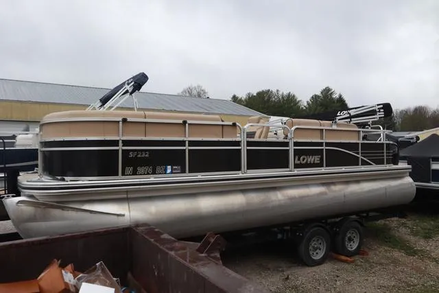 Slide: The Image of 2017 Lowe SF 232 pontoon boat on trailer, parked outdoors. - 1