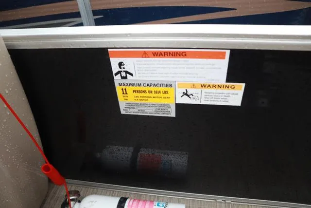 Slide: The Image of Warning labels on 2017 Lowe SF 232 boat, indicating maximum capacity and safety instructions. - 11