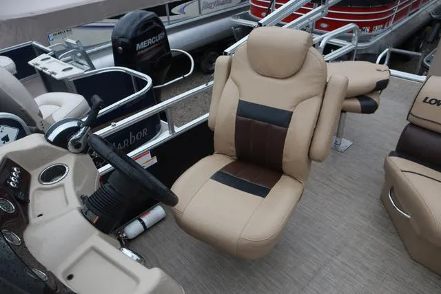 Slide: The Image of 2017 Lowe SF 232 boat interior with beige captain's chair and steering wheel. - 12