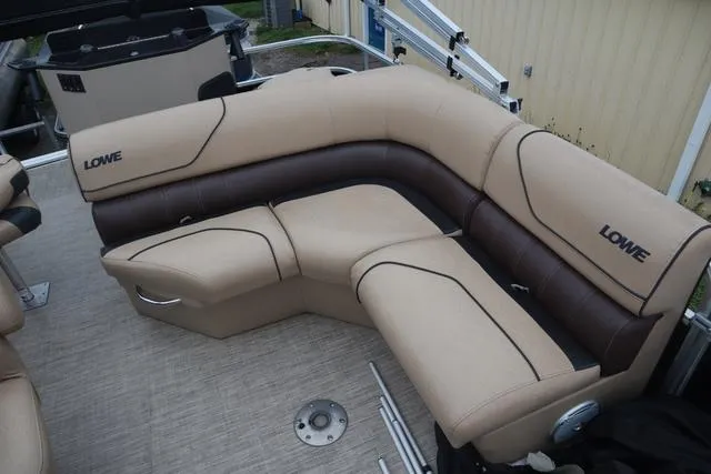 Slide: The Image of 2017 Lowe SF 232 boat interior with beige and brown seating. - 13
