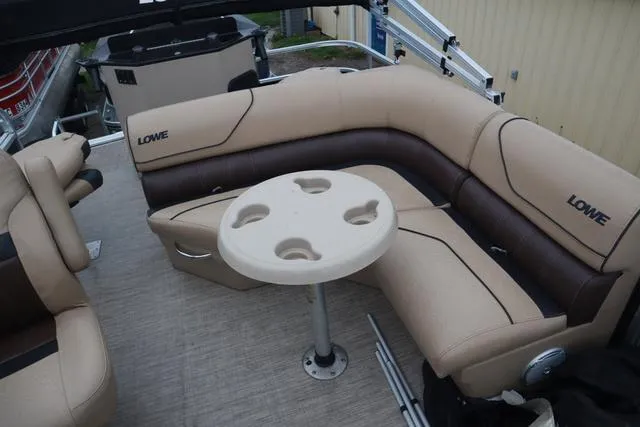 Slide: The Image of 2017 Lowe SF 232 boat interior with beige seating and round table. - 14