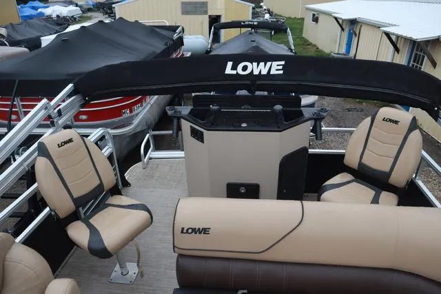 Slide: The Image of 2017 Lowe SF 232 pontoon boat interior with beige seating and black accents. - 15