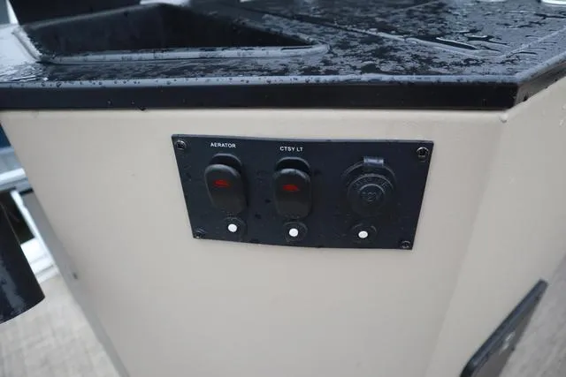 Slide: The Image of Control panel on a 2017 Lowe SF 232 boat, featuring switches and outlets. - 17