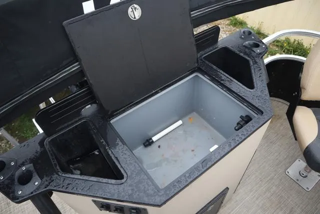 Slide: The Image of 2017 Lowe SF 232 boat with open storage compartment and cup holders. - 18