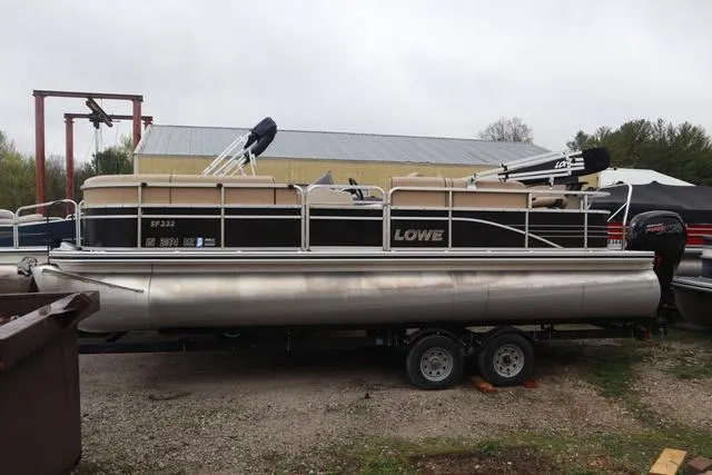 Slide: The Image of 2017 Lowe SF 232 pontoon boat on trailer, parked outdoors. - 2