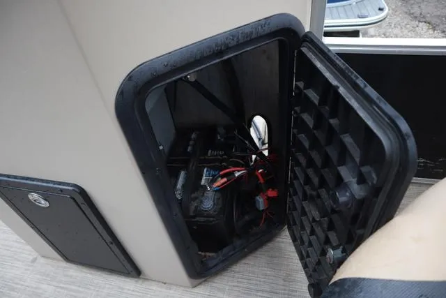 Slide: The Image of 2017 Lowe SF 232 boat battery compartment with open hatch, showing wiring and battery. - 20